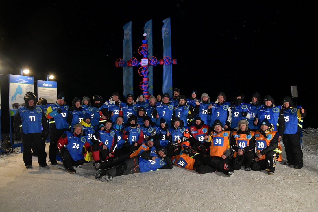 Участники снегоходного пробега у памятного знака на скважине Р-2